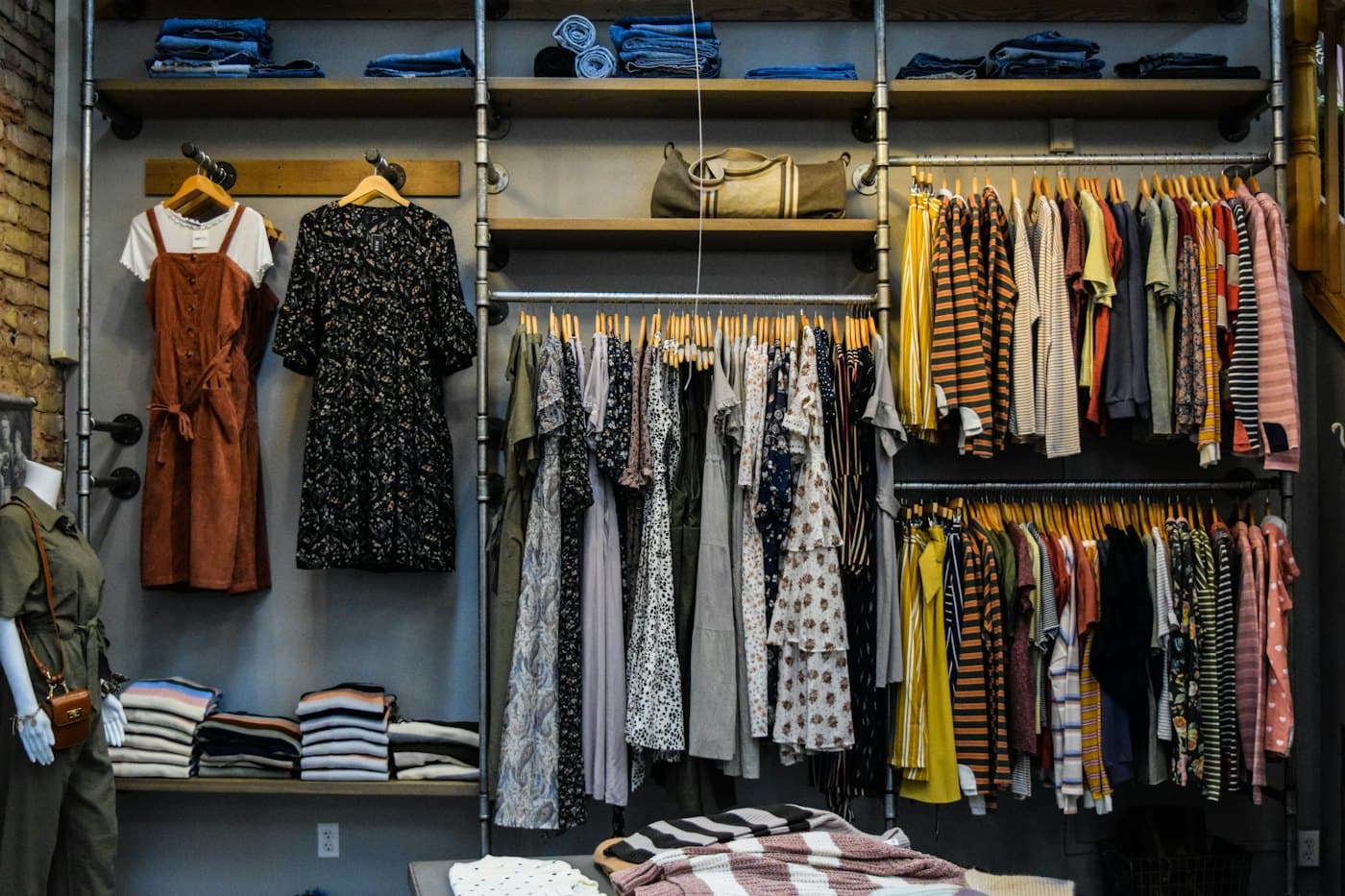 Boutique clothing rails with patterned dresses and knitwear